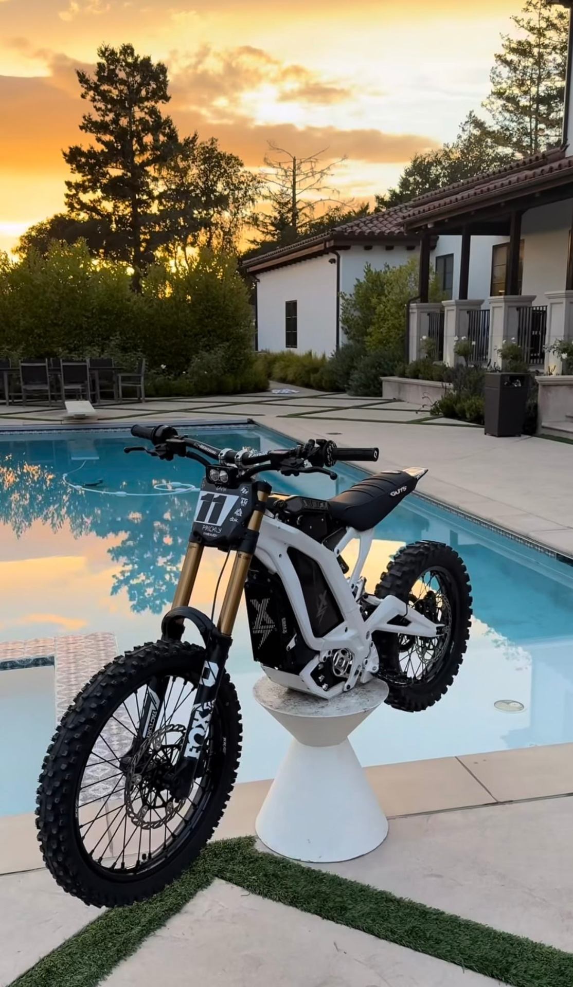 White Sur-Ron build poolside at sunset